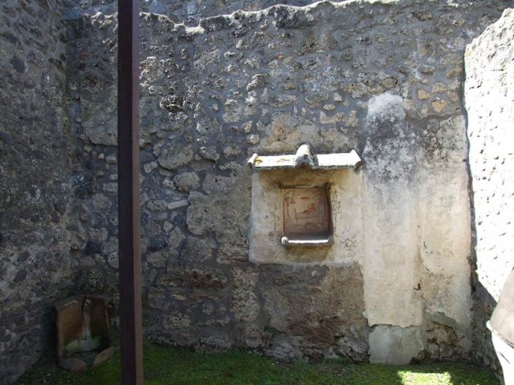 I.14.7 Pompeii. March 2009. West wall of the garden area with another niche lararium.