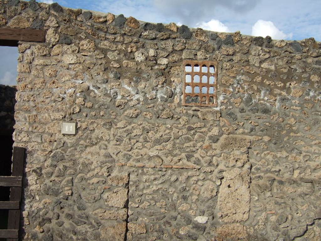 I.14.11 Pompeii. December 2005. Window on east side of entrance doorway. According to Eschebach this is a terracotta window.
See Eschebach, L., 1993. Gebäudeverzeichnis und Stadtplan der antiken Stadt Pompeji. Köln: Böhlau. (p.71)
