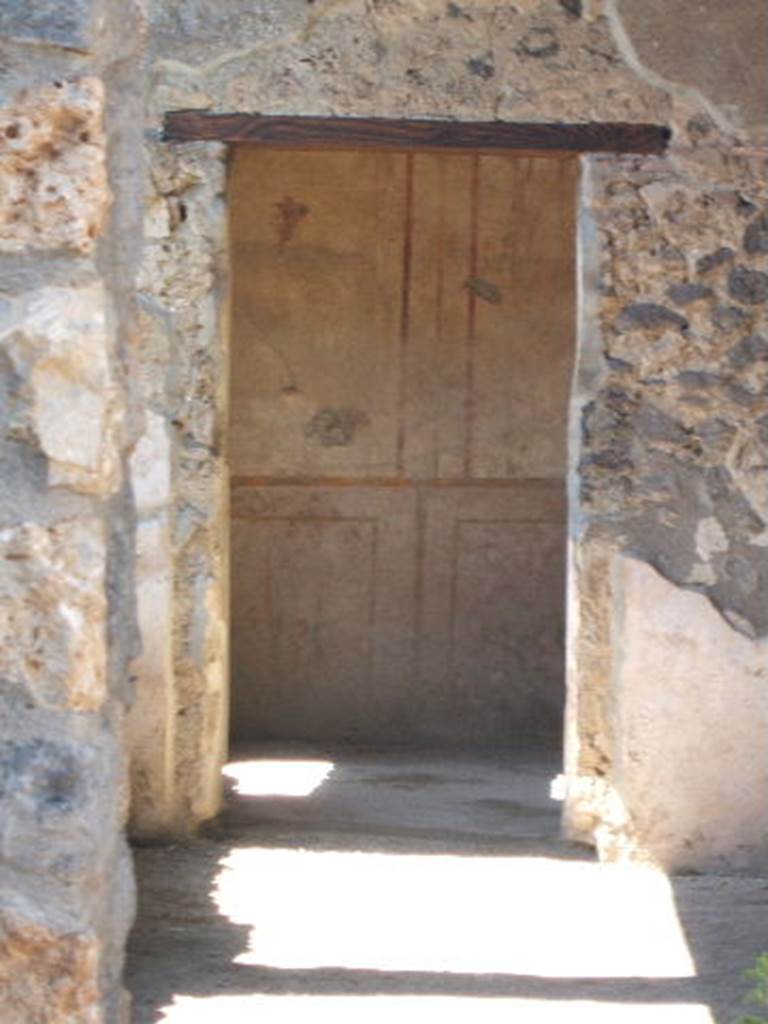 I.14.12 Pompeii. May 2005. Doorway to room 2 on east side of peristyle, taken from I.14.13
