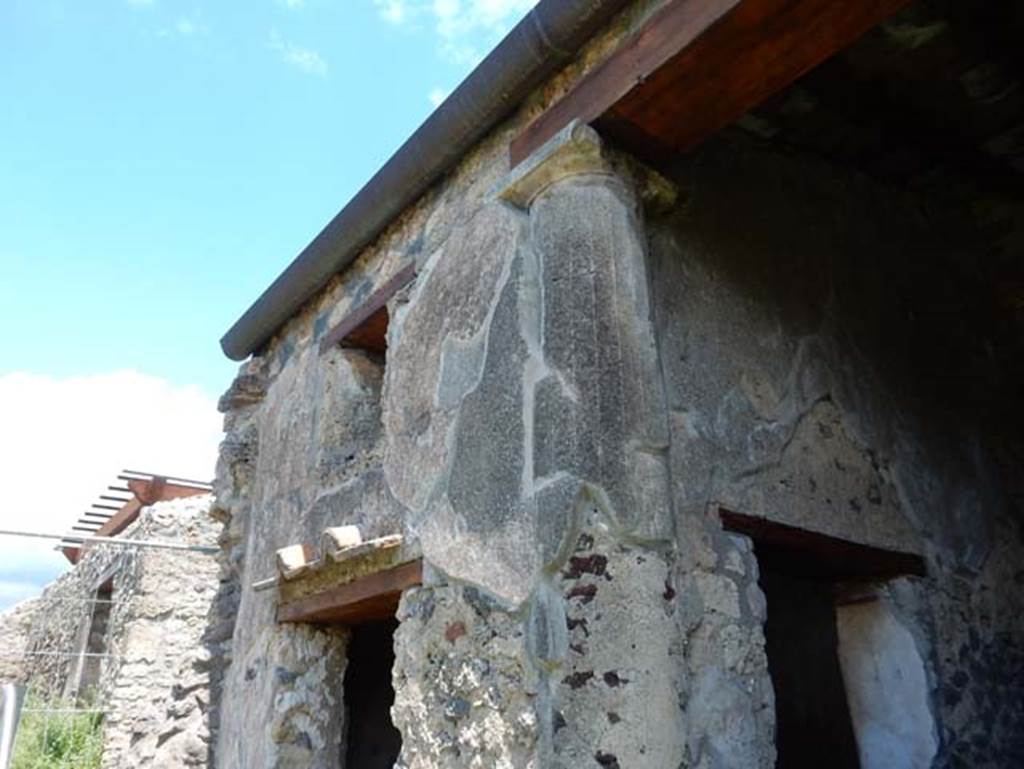 I.14.12, Pompeii. May 2018. Room 2, exterior east wall with window and doorway from peristyle garden. When this room was constructed one of the columns of the original peristyle was embedded into the south-west corner of the room.
Photo courtesy of Buzz Ferebee.