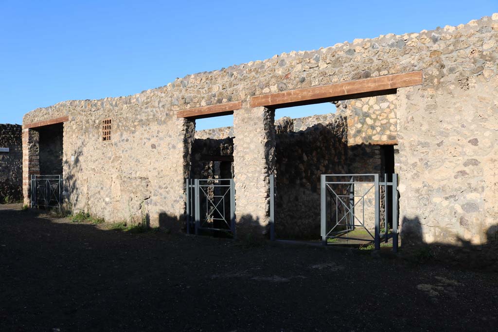 I.14.11, on left, I.14.12, centre, and I.14.13 on right, Pompeii. December 2018.
Looking north to entrance doorways. Photo courtesy of Aude Durand.