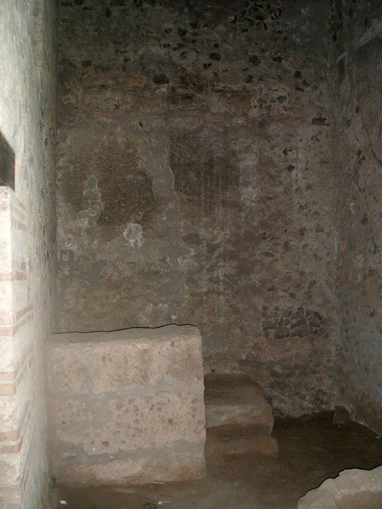 I.15.3 Pompeii. December 2004.
Room 9. Kitchen looking west to steps to upper floor. The doorway to the latrine is on the left.