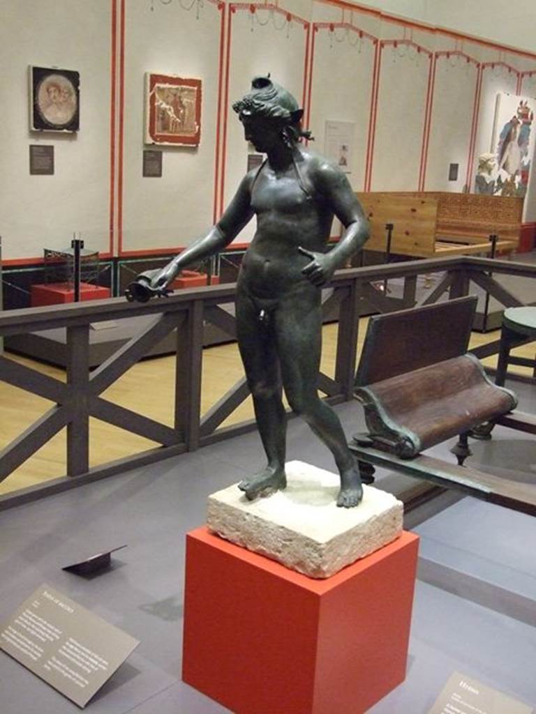 I.16.2 Pompeii. Found 26th September 1957. Bronze statue of Bacchus. SAP 11864. Photographed at “A Day in Pompeii” exhibition at Melbourne Museum. September 2009. This is shown in Rediscovering Pompeii as I.18.2 which is the original numbering, which has since been renumbered to I.16.2. See Conticello, B., Ed, 1990. Rediscovering Pompeii. Rome: L’Erma di Bretschneider. (p. 267).