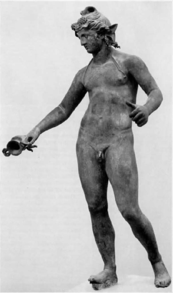 I.16.2, Pompeii. Bronze statue of a young Bacchus.
Found in a cubiculum adjacent to the fauces, on 26th September 1957.
Then on display in Pompeii Antiquarium, see VIII.1.4. SAP inv. No. 11864.
It was found with many other bronze household goods/furnishings in a cubiculum of the atrium.
See Elia, O., 1961. Bacco Fanciullo e Dioniso Chtonio a Pompei: Bollettino d’Arte 1961, Fasc I-II, (p.1.fig.1).
See Rediscovering Pompeii, IBM catalogue, 1990-92, no.187, p.266-7.