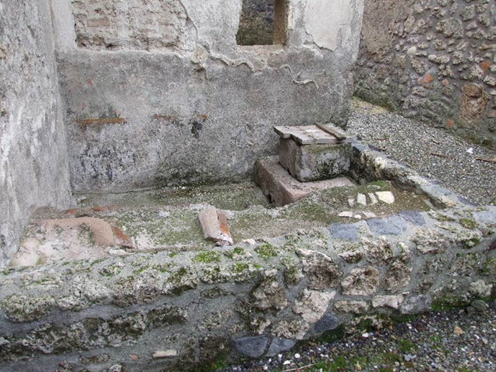 I.16.3 Pompeii. December 2006. Looking south towards rectangular small garden (light-yard?), or pool? According to Jashemski, the stucco altar and serpent were on a wall above a pool. There may have been some potted plants on the top of the north side of the low wall that enclosed the small pool built against the light well’s south and east walls. Such plants would have supplemented the impression of a garden suggested by the garden painting on the wall above the pool. See Jashemski, W. F., 1993. The Gardens of Pompeii, Volume II: Appendices. New York: Caratzas. (p.64)