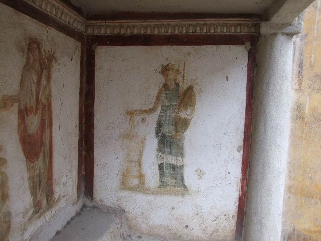 I.16.3 Pompeii. December 2006. North wall in lararium. Detail of painting of Minerva with sacrifice in a dish in her right hand held over a round altar. See Fröhlich, T., 1991. Lararien und Fassadenbilder in den Vesuvstädten. Mainz: von Zabern, L35 p. 264, taf. 5,3.