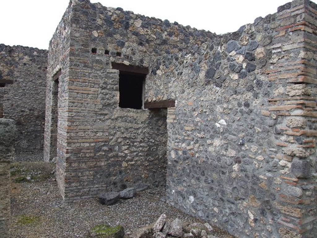 I.16.4 Pompeii. December 2006. Looking north from garden towards doorway to summer triclinium, and doorway to kitchen (centre). The mound at the front of the doorway to the summer triclinium is the Sarno Canal which passes through the house