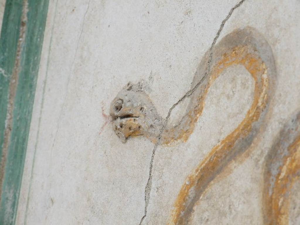 I.16.4 Pompeii. December 2006. Detail showing stucco head of serpent and painted body.