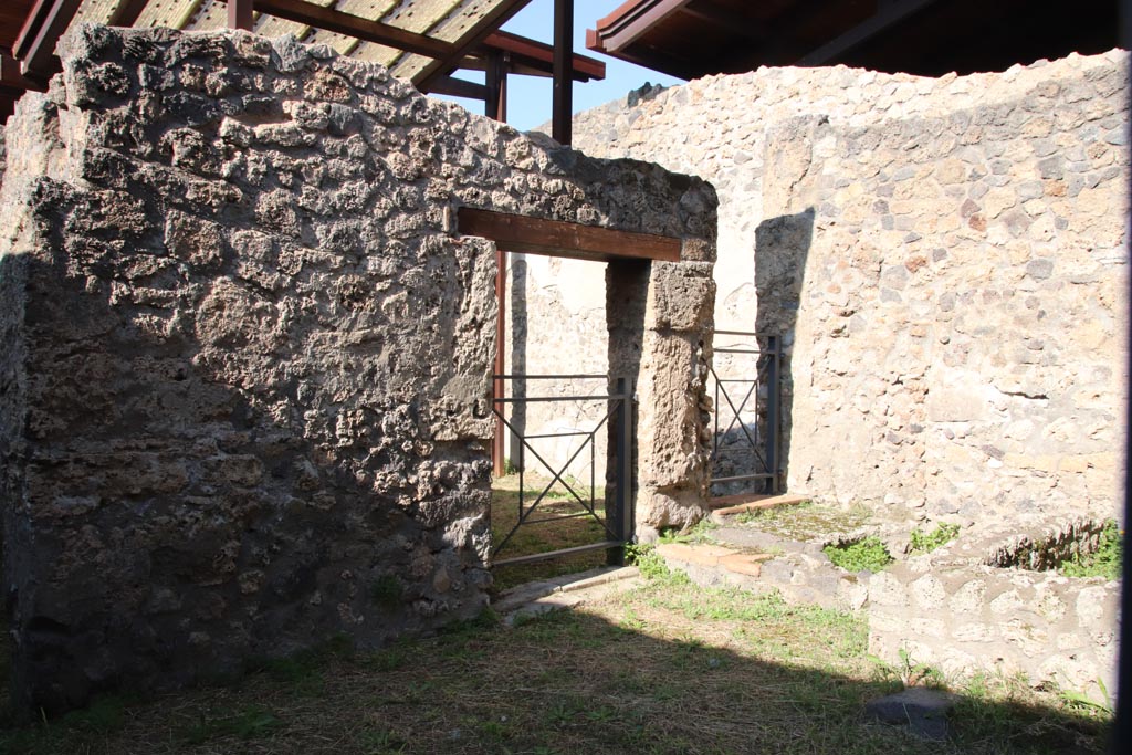I.20.3 Pompeii October 2022.
Looking north-west from doorway of I.20.2 towards doorways into rear room of I.20.3. Photo courtesy of Klaus Heese.