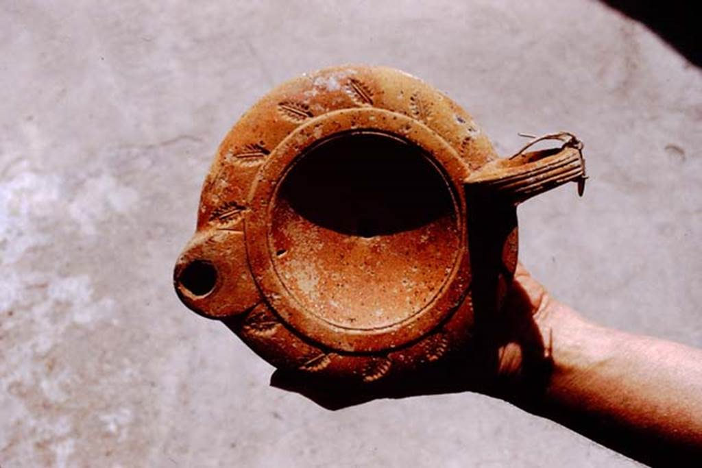 I.20.3 Pompeii. 1972. Example of type of lamp found here. Photo by Stanley A. Jashemski.
Source: The Wilhelmina and Stanley A. Jashemski archive in the University of Maryland Library, Special Collections (See collection page) and made available under the Creative Commons Attribution-Non Commercial License v.4. See Licence and use details. J72f0114