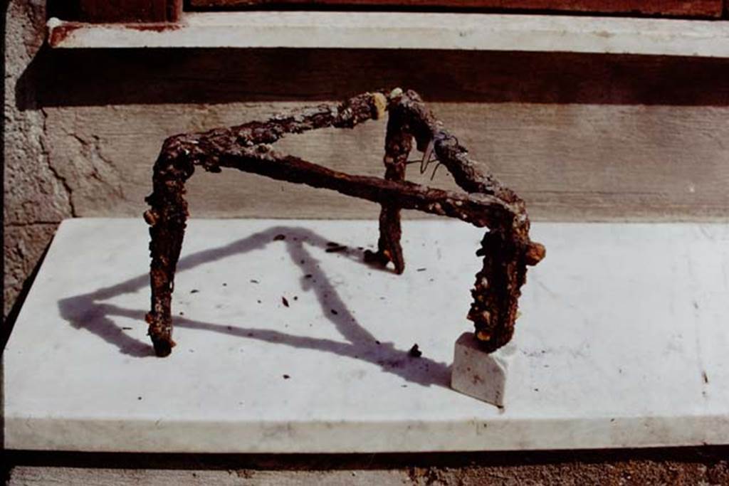 I.20.5 Pompeii. 1973. Iron tripod used for cooking. Photo by Stanley A. Jashemski.
Source: The Wilhelmina and Stanley A. Jashemski archive in the University of Maryland Library, Special Collections (See collection page) and made available under the Creative Commons Attribution-Non Commercial License v.4. See Licence and use details. J73f0570