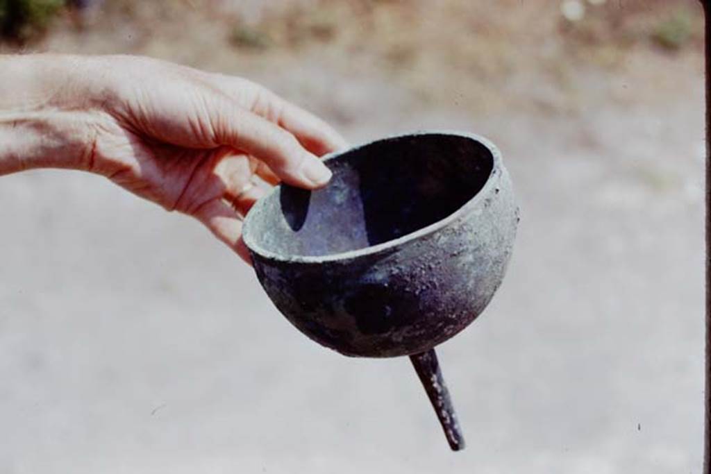 I.20.5 Pompeii. 1973. Bronze funnel found by the original excavators. Photo by Stanley A. Jashemski.
Source: The Wilhelmina and Stanley A. Jashemski archive in the University of Maryland Library, Special Collections (See collection page) and made available under the Creative Commons Attribution-Non Commercial License v.4. See Licence and use details. J73f0578
See Cronache Pompeiane 1, 1975: Jashemski, W. The gardens of Pompeii, (p.69-71).