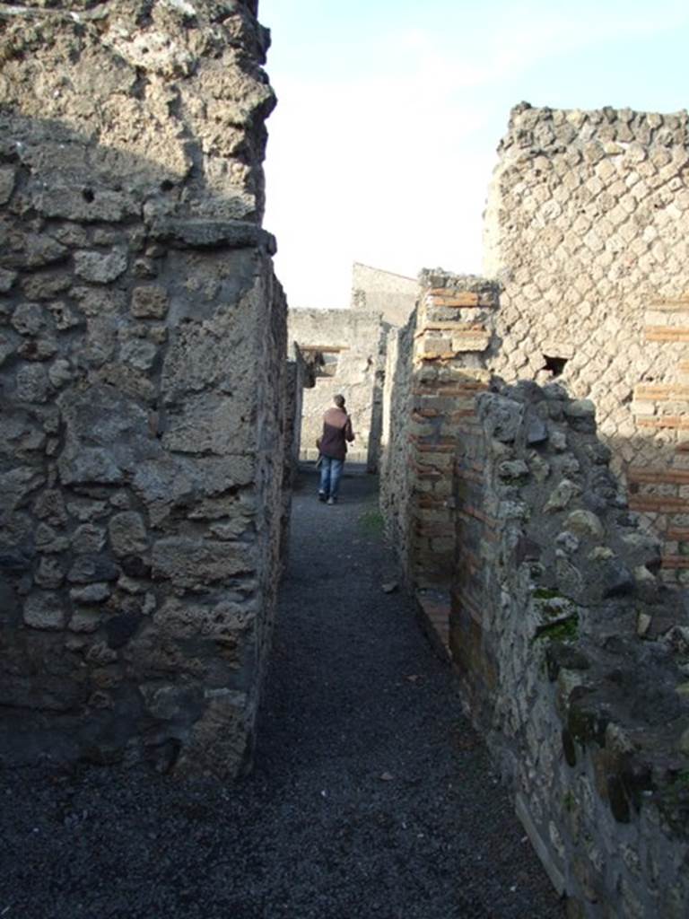 II.1.3. Corridor looking north towards entrance from rear room. The door on the right in the corridor leads to II.1.4.