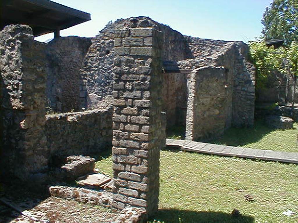 II.1.8 Pompeii. May 2005. Looking north-west from doorway. According to Jashemski, the small room on the left side of the entrance doorway was excavated in 1985. It was found to have a treading floor, where grapes were pressed by foot. The juice flowed into a small dolium. The presence of the treading floor suggested that the garden had been planted in vines to provide grapes for wine that was made on the site. See Jashemski, W. F., 1993. The Gardens of Pompeii, Volume II: Appendices. New York: Caratzas. (p.75) See II.1.9 for more photos, and that the garden has now been replanted in vines.