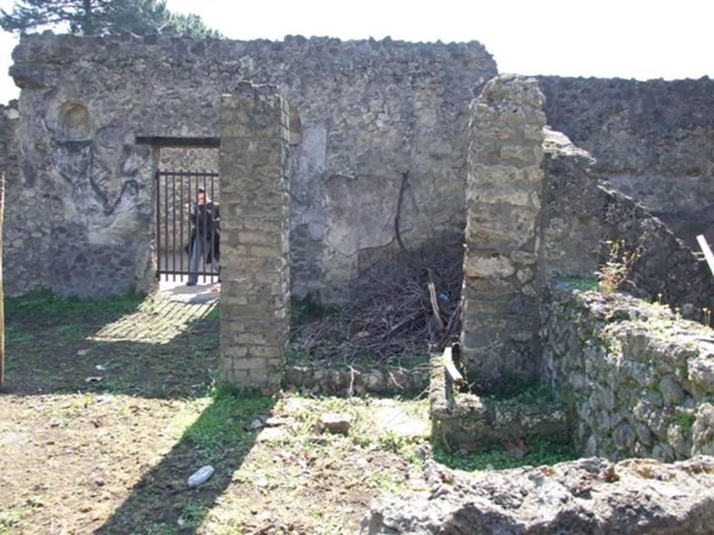 II.1.9 Pompeii. March 2009. Looking south from Latrine to Room 7, small room on south side of garden, and rear door at II.1.8
