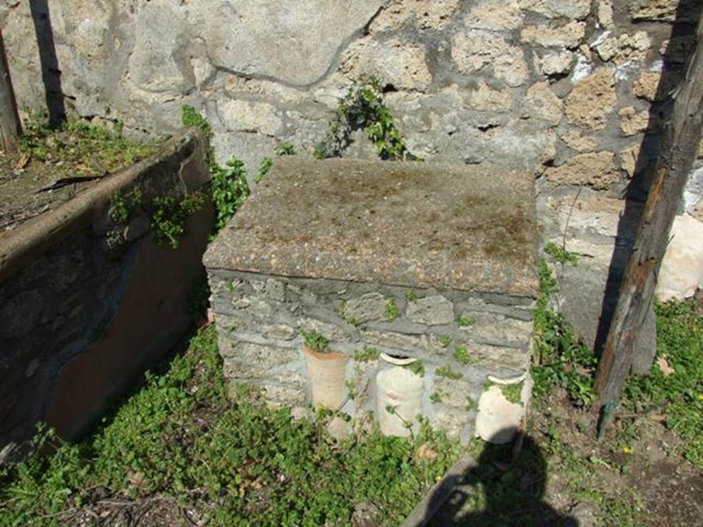II.1.9 Pompeii. March 2009. Garden area. Looking north at altar table, with jars.