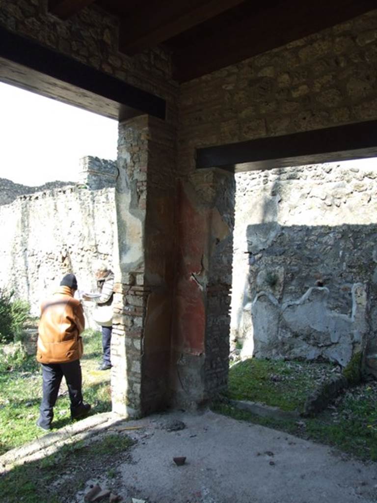 II.1.12 Pompeii. March 2009. Pillar on north side. Various graffiti were found on the pillars at each side of the door. Behind the pillar, against the north wall, can be seen the second small storeroom.