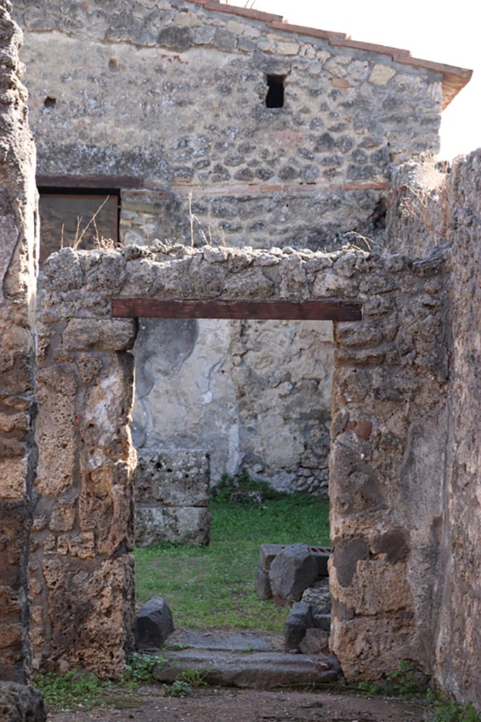 II.1.13 Pompeii. October 2023.
Looking south through doorway of dining room, photo taken from II.1.1. Photo courtesy of Klaus Heese.