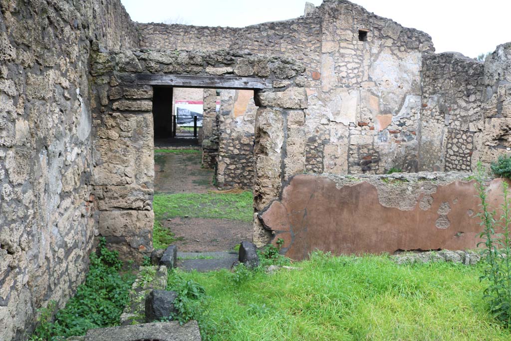 II.1.1/13 Pompeii. December 2018.
Looking towards north-west corner with doorway into large dining room and through to front of bar-room. Photo courtesy of Aude Durand.