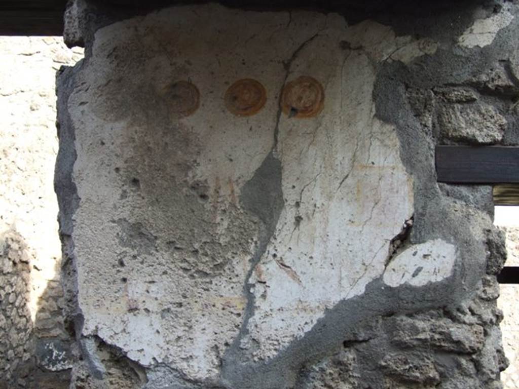 II.1.13 Pompeii. December 2007. Detail of painted plaster on exterior wall.
Inn sign? Two men with stick or cudgel, and three hanging shields.
See Bragantini, de Vos, Badoni, 1981. Pitture e Pavimenti di Pompei, Parte 1. Rome: ICCD. (p.212). See Fröhlich, T., 1991. Lararien und Fassadenbilder in den Vesuvstädten. Mainz: von Zabern. (F15)