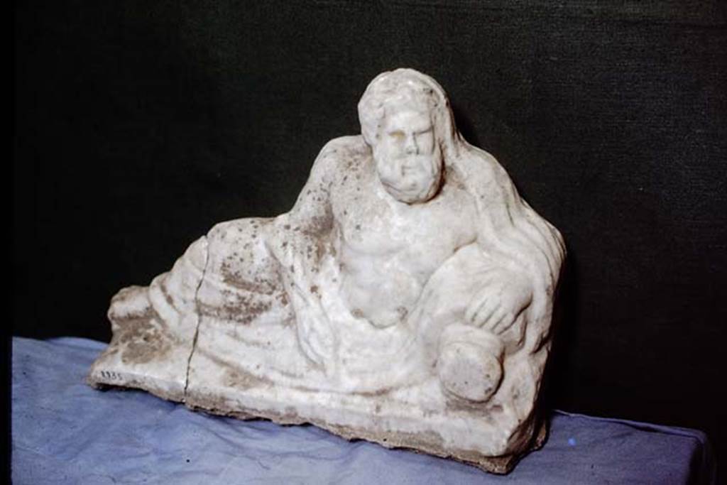 II.2.2. Pompeii. 1978. Room “k”. White marble statuette of a river god. Photo by Stanley A. Jashemski.
Source: The Wilhelmina and Stanley A. Jashemski archive in the University of Maryland Library, Special Collections (See collection page) and made available under the Creative Commons Attribution-Non Commercial License v.4. See Licence and use details. J78f0169