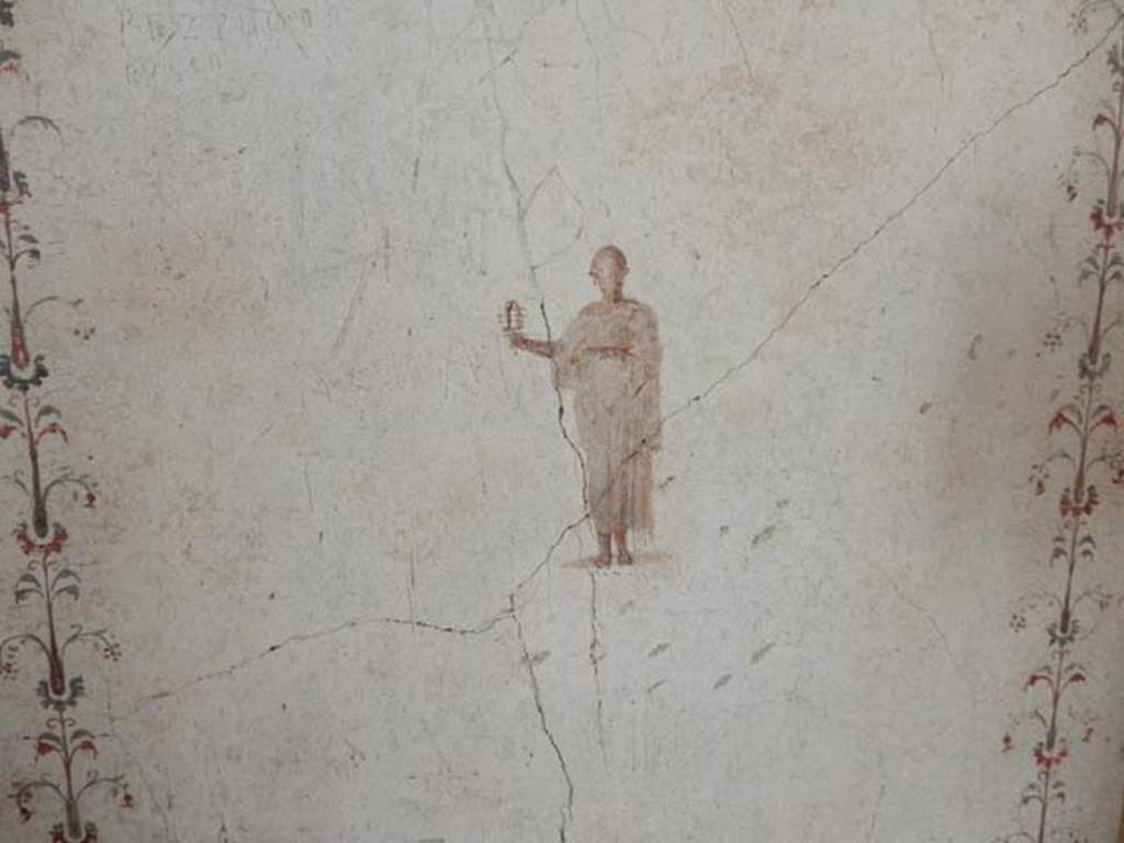 II.2.2 Pompeii. May 2016. Room “f”, painted priest of Isis from west end of south wall.
Photo courtesy of Buzz Ferebee.