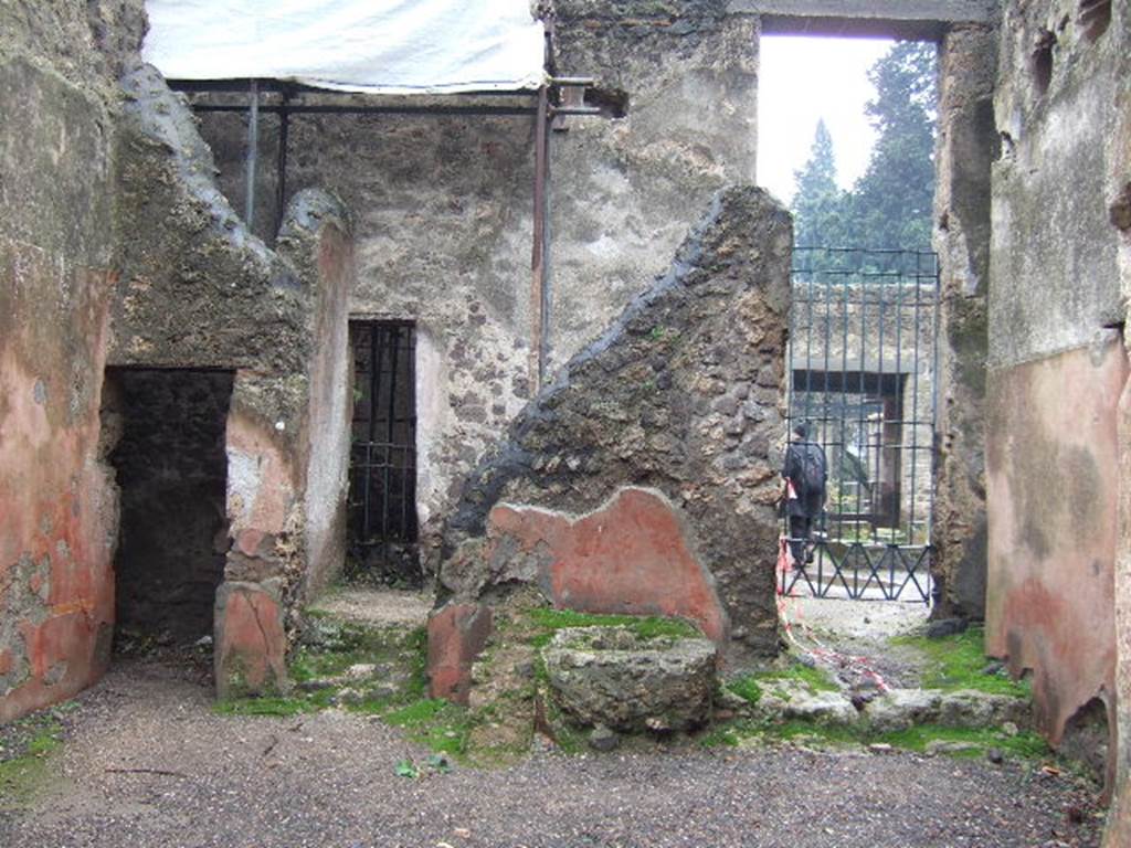 II.2.3 Pompeii. December 2005. South wall, with doorways to small cubiculum, room 3 and atrium of II.2.2. According to Eschebach, near the rear wall are two steps leading to the stairs to upper floor. Under the stairs would have been the cistern mouth. See Eschebach, L., 1993. Gebäudeverzeichnis und Stadtplan der antiken Stadt Pompeji. Köln: Böhlau. (p.89)

