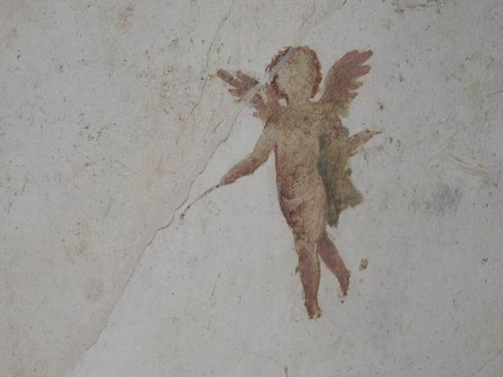 II.3.3 Pompeii. May 2016. Room 4, painting of flying cherub/cupid from west end of south wall.
Photo courtesy of Buzz Ferebee.