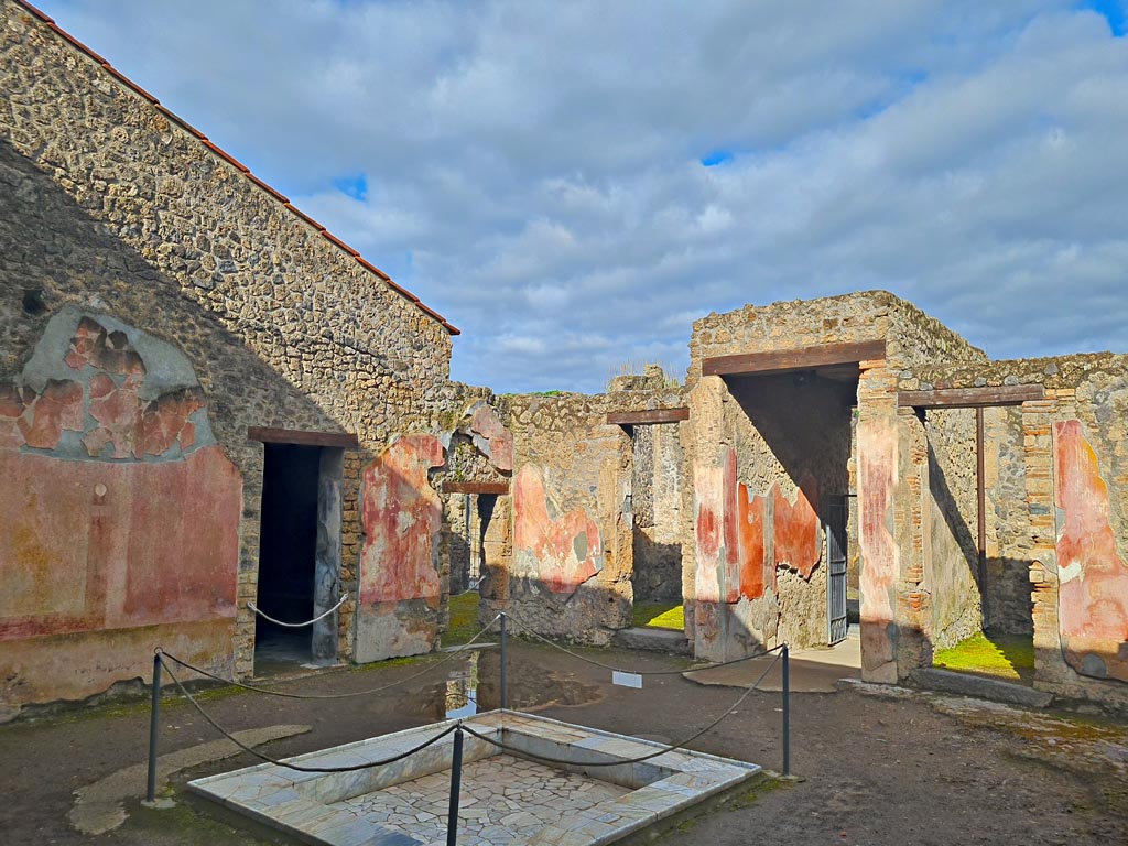 II.3.3 Pompeii. March 2024.
Room 2, looking across impluvium in atrium towards north-west corner. Photo courtesy of Giuseppe Ciaramella.