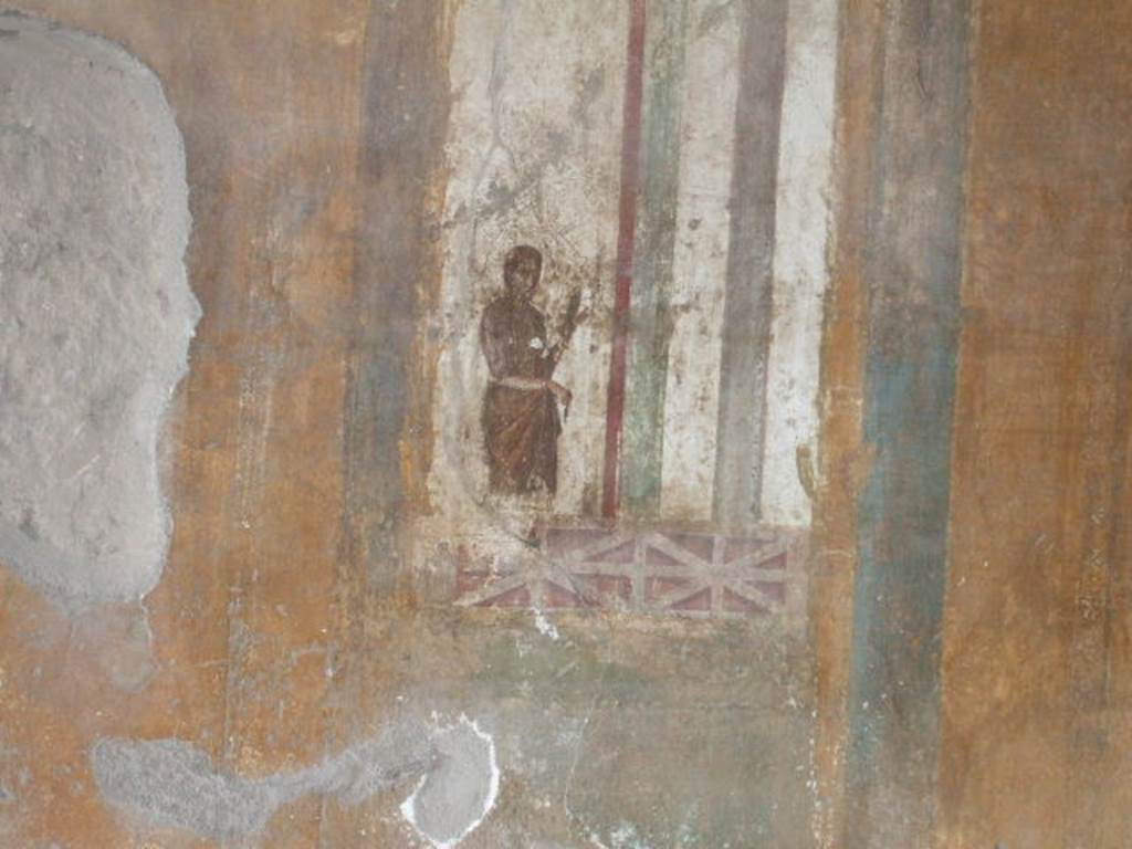 II.3.3 Pompeii. December 2005. Room 9, Oecus. North wall. Painting of figure in architectural setting.