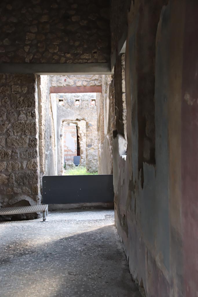 II.4.2 Pompeii. October 2022.
Looking south from doorway of steps to upper floor towards a corridor leading to rear. Photo courtesy of Klaus Heese