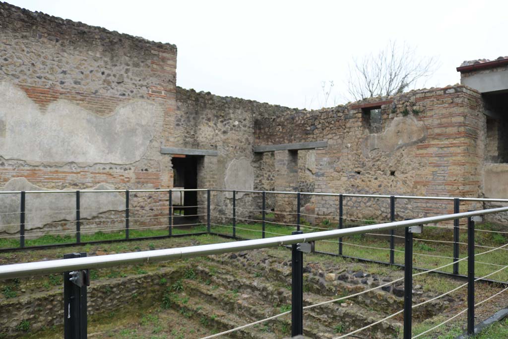 II.4.6 Pompeii. December 2018.
Looking north-west across swimming pool, towards doorway into portico of baths’ area, with 11.4.7, on right. Photo courtesy of Aude Durand.