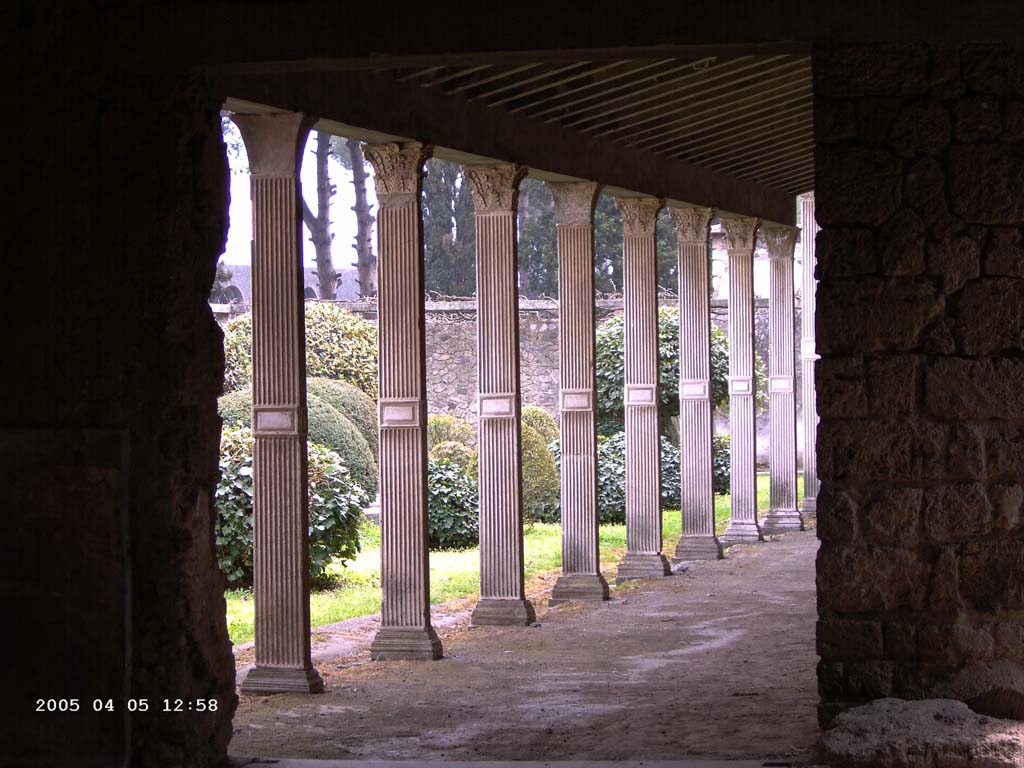 II.4.3 Pompeii. April 2005. Looking south from doorway in south-east corner of atrium, along west portico (of II.4.6).
Photo courtesy of Klaus Heese.