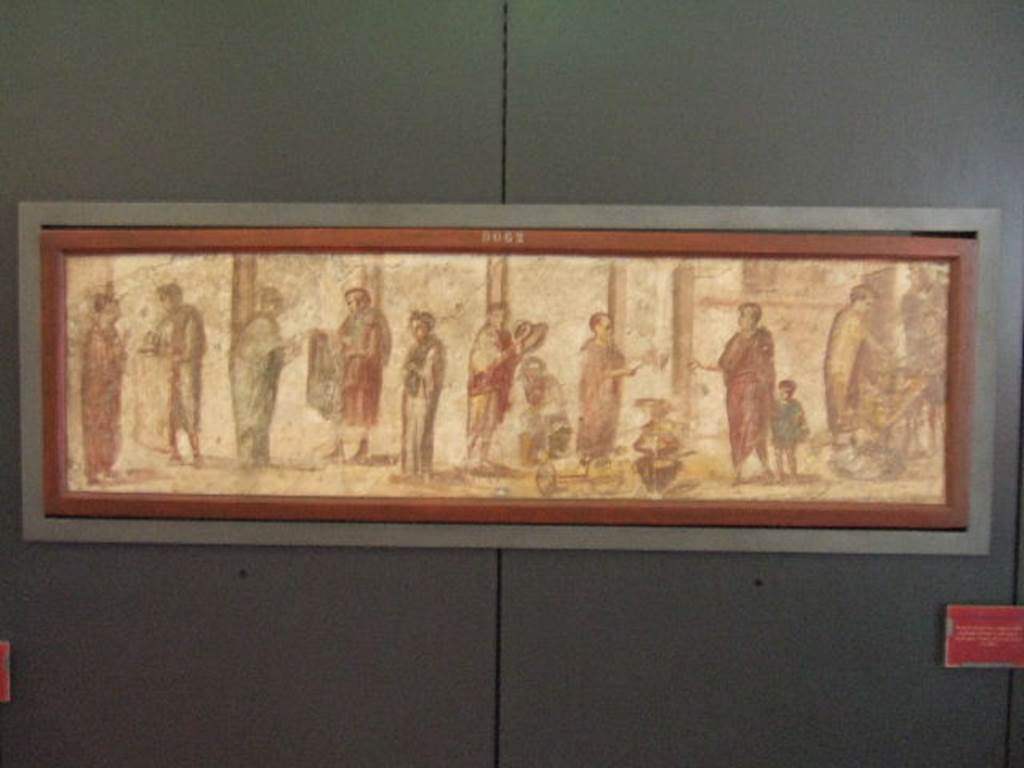 II.4.3 Pompeii. Part of the “Forum Frieze”. Sale of clothing, pots and other objects. Found on east wall of the atrium. Now in Naples Archaeological Museum. Inventory number 9063.
This painting shows the same inventory number (9062) on its frame as the painting of the chariot and the donkey. According to Pagano and Prisciandaro the sale of clothing picture is 9063 and the chariot and the donkey is 9062. See Pagano, M. and Prisciandaro, R., 2006. Studio sulle provenienze degli oggetti rinvenuti negli scavi borbonici del regno di Napoli. Naples: Nicola Longobardi. (p. 16 and inventory list in second volume). See Accademici Ercolanesi, 1762. Le Pitture Antichita di Ercolano: Tome III. (p. 221, Tav.42).