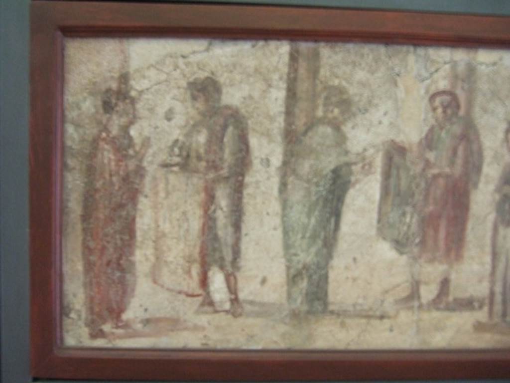 II.4.3 Pompeii. Close up of part of the “Forum Frieze”. Sale of clothing. Found on East wall of the atrium. Now in Naples Archaeological Museum. Inventory number 9063.