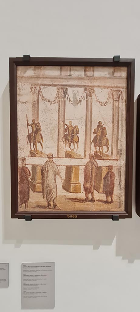 Paintings of the Forum frieze, on display in “Campania Romana” gallery in Naples Archaeological Museum.
Above (inv. 9068) - Lettura di iscrizione affissa su tre basi di statue. (Reading of inscription affixed on three statues bases).
Photo courtesy of Giuseppe Ciaramella.
.