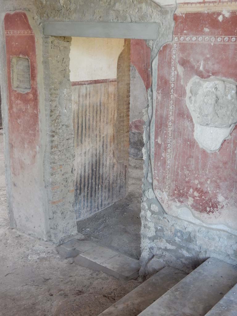 II.4.10 Pompeii. June 2019. Doorway in west wall of atrium, at base of steps from portico.
Photo courtesy of Buzz Ferebee.