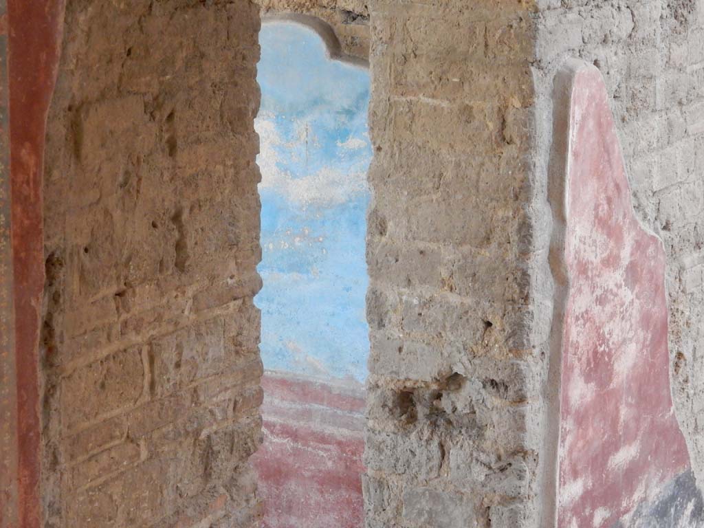 II.4.10 Pompeii. June 2019. Looking south-east through doorway, towards south wall of biclinium.
Photo courtesy of Buzz Ferebee.