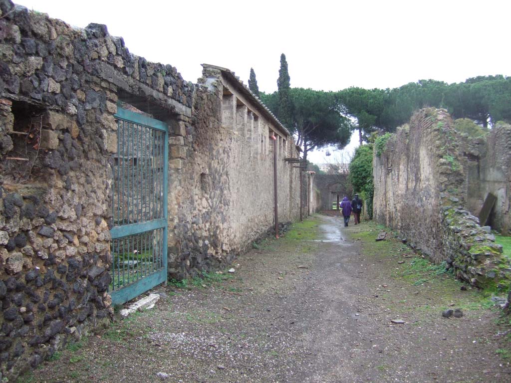 II.4.12 Pompeii, on left. December 2006. Roadway looking south. II.3, on right.