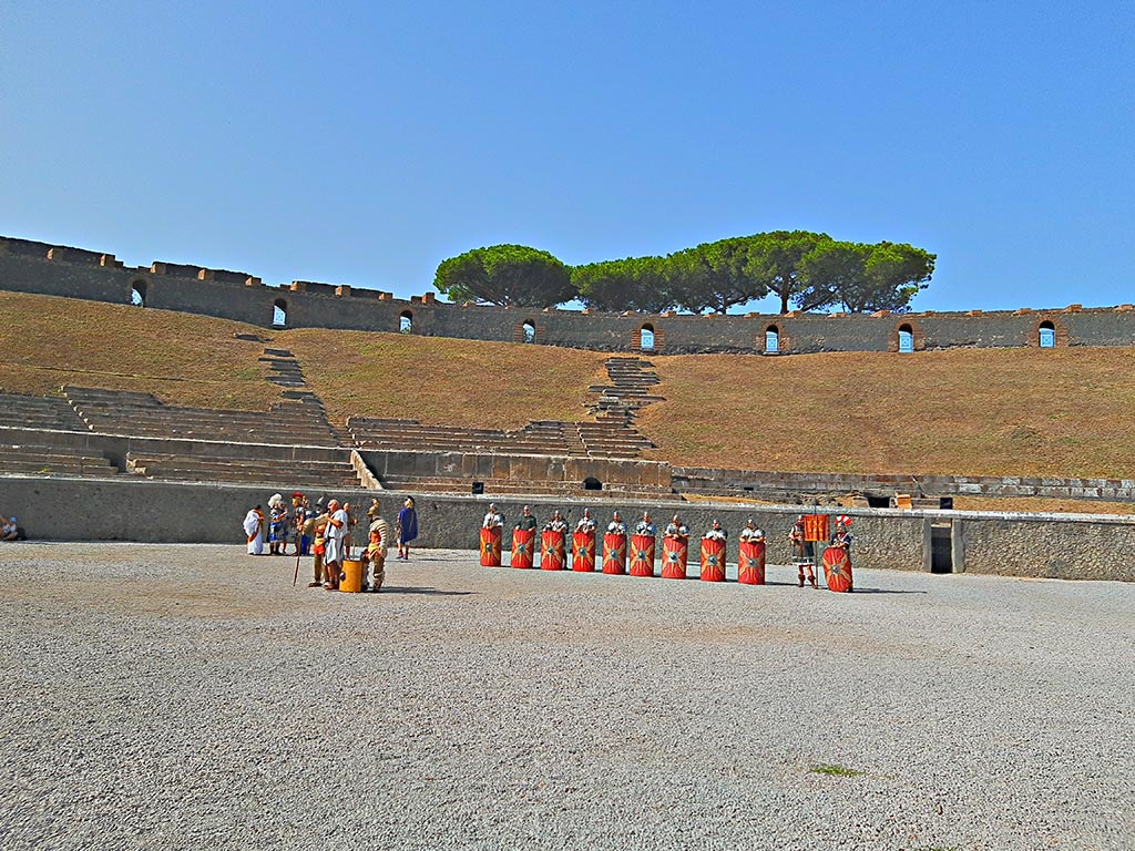II.6 Pompeii. September 2024.
Looking west across amphitheatre towards site of preview/rehearsal for a larger event, including Gladiators and Roman Soldiers.
Photo courtesy of Giuseppe Ciaramella.