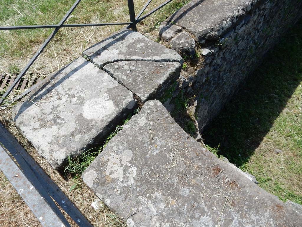 II.7 Pompeii. June 2019. Detail of edging in south-east corner. Photo courtesy of Buzz Ferebee
From here came the overflow that cleansed the latrine.
According to NdS in 1939, "Water channelling systems can also be seen in Pompeii in the large latrine of the private Gymnasium building in Via delle Scuole, and in the latrines of the Villa of the Mysteries and elsewhere, but this one in the Amphitheatre Gymnasium is the first example in Pompeii of the rational use of a large cistern system for draining a public latrine".
See Notizie degli Scavi di Antichità, 1939, p. 192, note 4.