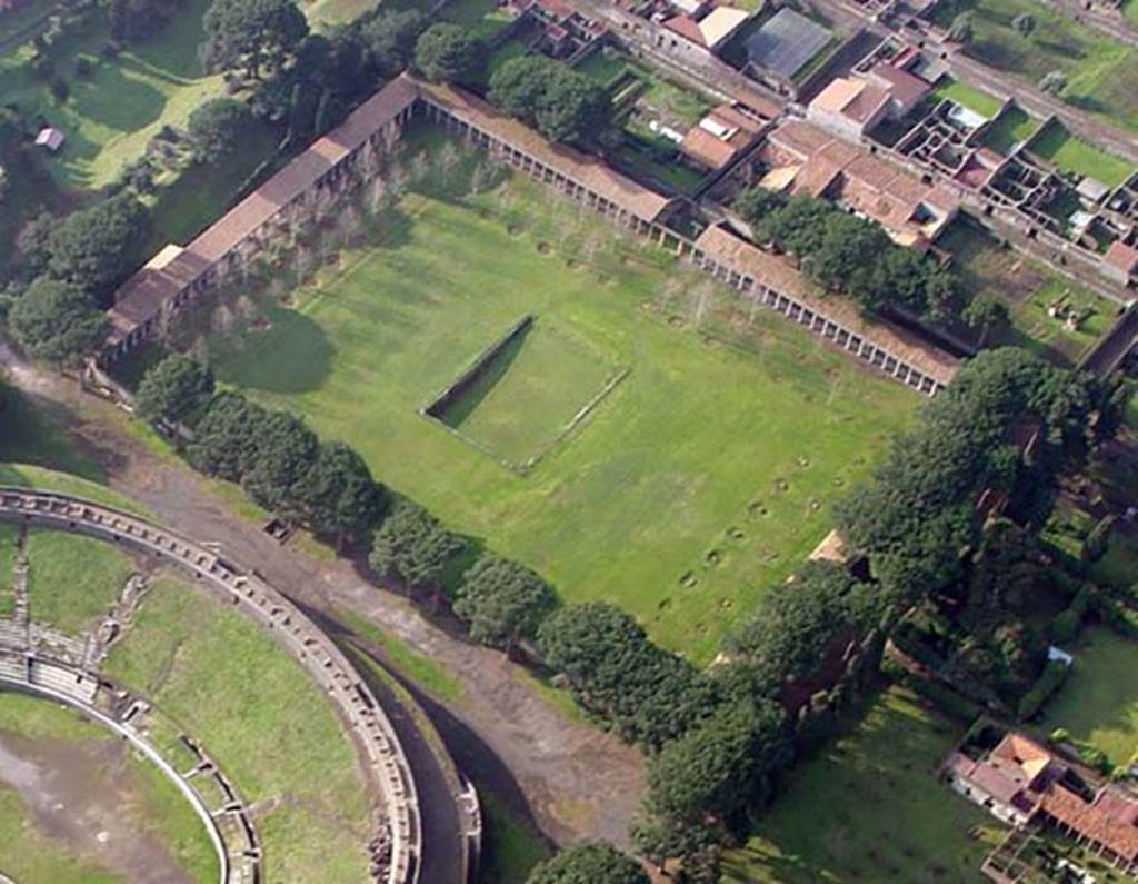 II.7.3 Pompeii. Palaestra. Looking towards south-west corner.
The overflow from the pool in the centre ran into a small drain, which flushed out the large latrine.
The roof of the latrine building is visible (left) against the south wall in the south-east corner.