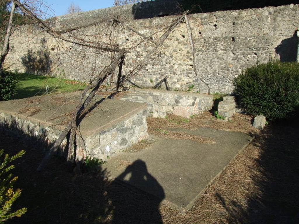 II.8.6 Pompeii. December 2006. Summer triclinium in garden, looking north-east.
According to Wilhelmina, near the triclinium the original excavators had found a human skeleton, two gold finger rings and five gold coins.
There were also seven medical instruments, two probes and a bronze strigil.
Found near the lararium was a marble statuette of Hercules, which had once stood in the lararium, so the garden was named the garden of Hercules.
See Jashemski, W.F., 2014. Discovering the Gardens of Pompeii: Memoirs of a Garden Archaeologist, p. 193.
