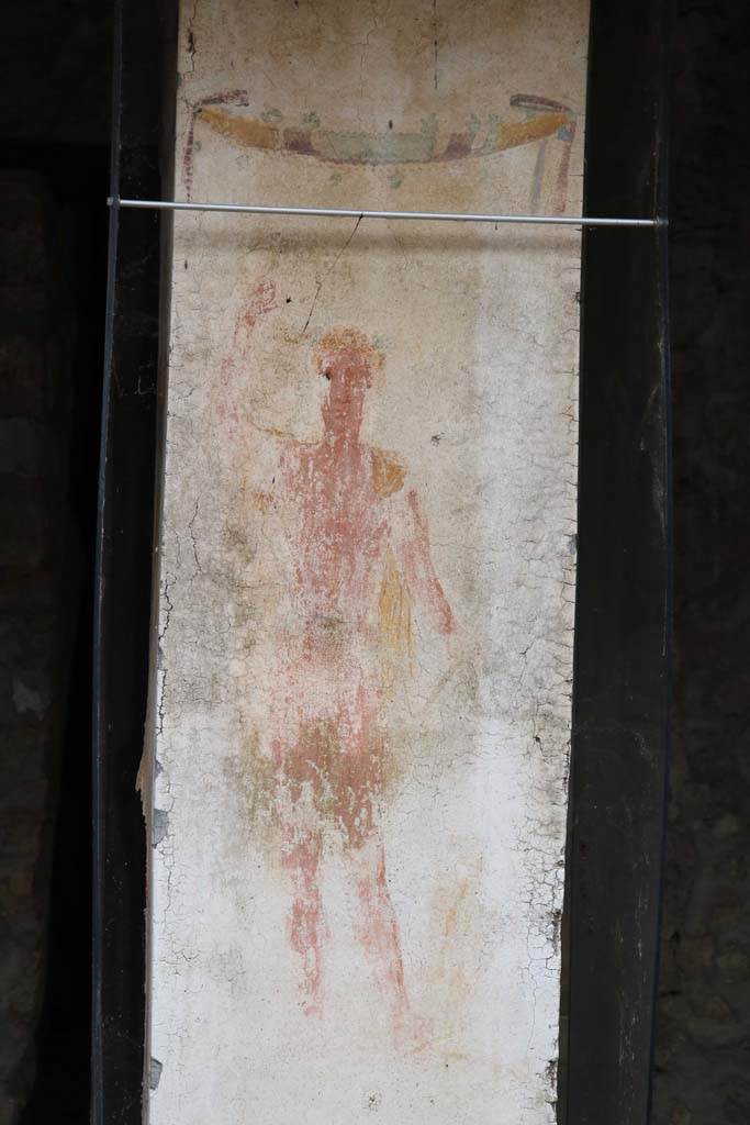 II.9.1 Pompeii. December 2018.
Detail of painting of Bacchus on south face of column on the north side of the triclinium 8.
Photo courtesy of Aude Durand.
Kuivalainen comments –
“A young half-naked Bacchus wearing a cloak is teasing a panther with a bunch of grapes. The large painting is very exceptional on a garden pillar. The strong jaw line is also seen in some Republican coins.”
See Kuivalainen, I., 2021. The Portrayal of Pompeian Bacchus. Commentationes Humanarum Litterarum 140. Helsinki: Finnish Society of Sciences and Letters, (p.115, C15).