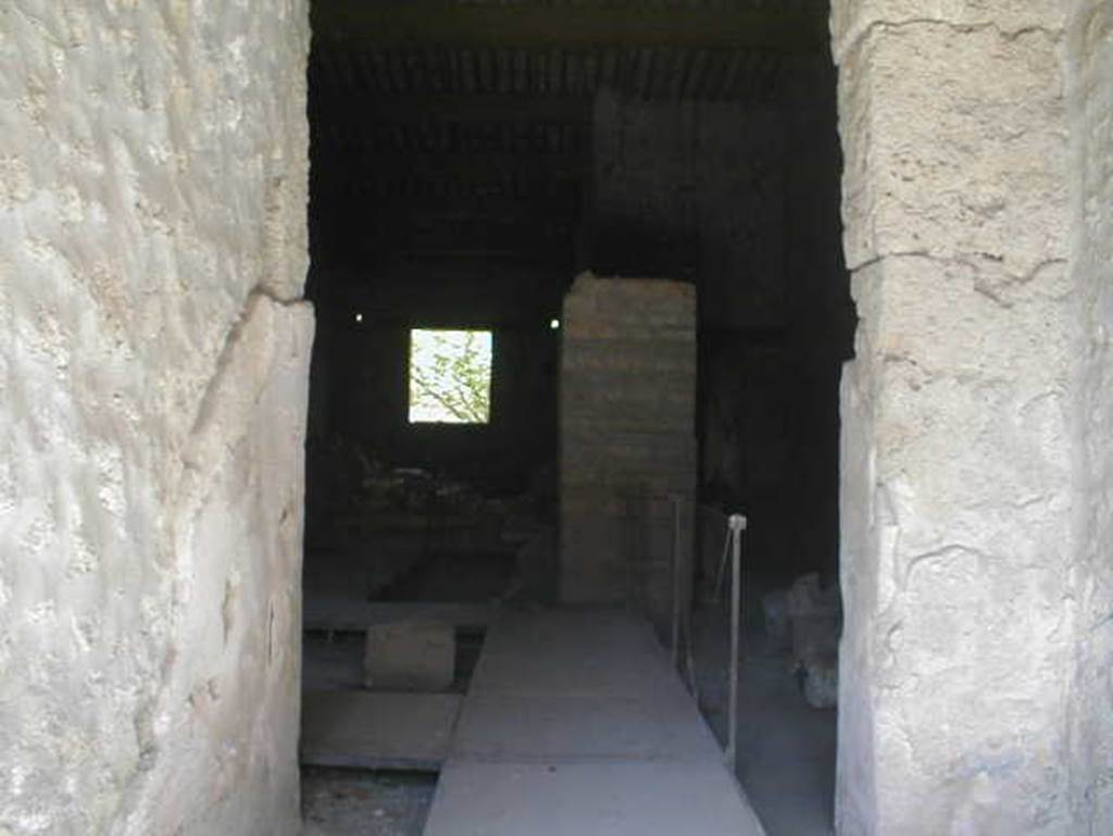 II.9.2 Pompeii. May 2005. Looking east from entrance corridor 1 into room 4.
In room 4, close to the north wall, two bronze boxes were found containing objects of particular value: gems and work tools, which make the house attributable to a gemmarius or gem cutter.
The stones were yellow jasper, chalcedony-agate, chalcedony-Sardinian, chalcedony-carnelian, chalcedony-carnelian, chalcedony-carnelian, chalcedony-carnelian, chalcedony blue, prasio, quartz stone, rock crystal, and there were three chisels.
See Attività della Soprintendenza: Regio II, Insula 9: Rivista di Studi Pompeiani II, 1988, p. 200, p. 202 note 12.