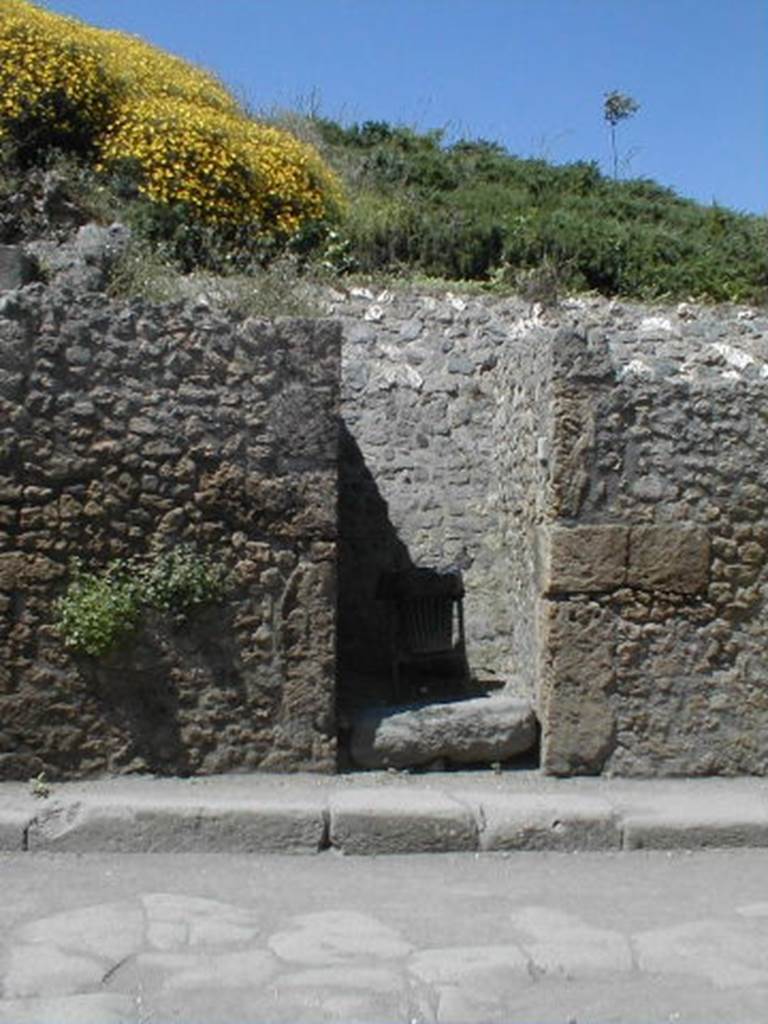 III.3.3 Pompeii. May 2005. Entrance doorway, partly excavated.
According to Garcia y Garcia, a bomb dropped during the bombardment of 19th September 1943 destroyed the façade of III.3.4.
This led to the disintegration of the pilasters and doorposts of three entrances, (III.3.3, III.3.4 and III.3.5).
Also ruined were the dividing walls and the perimeter wall onto Via dell’Abbondanza for 26 x 5 metres.
In III.3.5 the internal walls were also destroyed.
See Garcia y Garcia, L., 2006. Danni di guerra a Pompei. Rome: L’Erma di Bretschneider. (p.53)