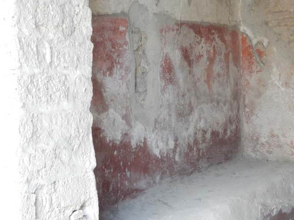 III.4.3 Pompeii. May 2017. Room 1, detail of remains of painted decoration on west wall above bench. Photo courtesy of Buzz Ferebee.