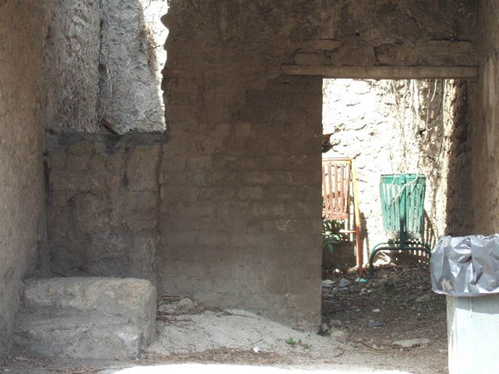 III.5.1 Pompeii. September 2005. Steps to upper floor with two steps remaining. To the right is the door to the rear room which has a window to the north, which is not excavated. According to Liselotte Eschebach, this may have been a grocery shop. The upstairs may have been rented out as a workshop. Tools and furniture fittings were found there. See Eschebach, L., 1993. Gebäudeverzeichnis und Stadtplan der antiken Stadt Pompeji. Köln: Böhlau. (p. 107).
