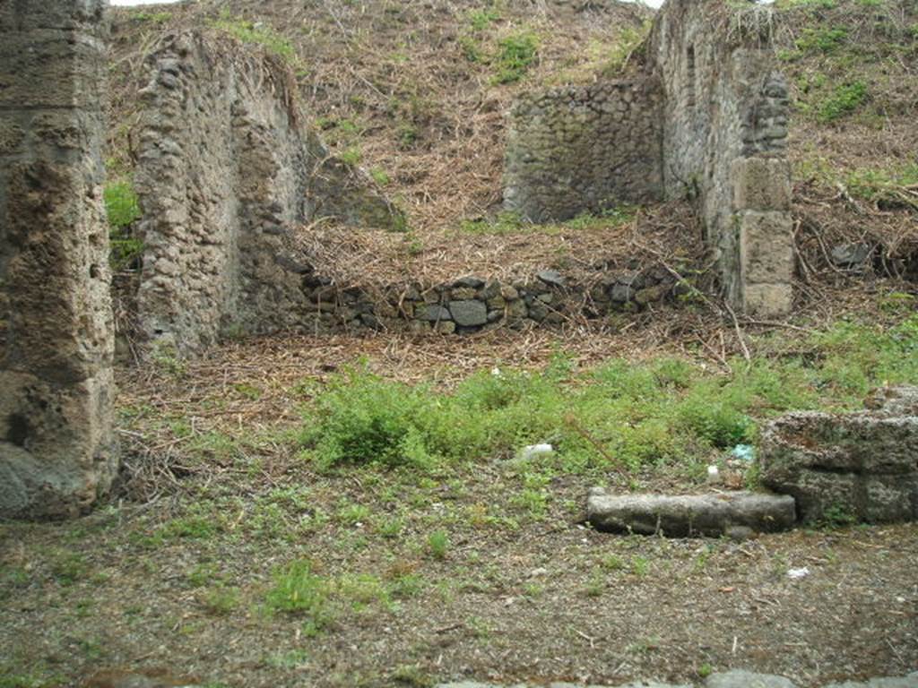 III.11.1 Pompeii. May 2005. Shop room of caupona in centre, with side room (on the left). Looking south.
It is difficult to reconcile the entrances in this insula with the plans as the entrances onto Via Nola have been filled in or are unexcavated.