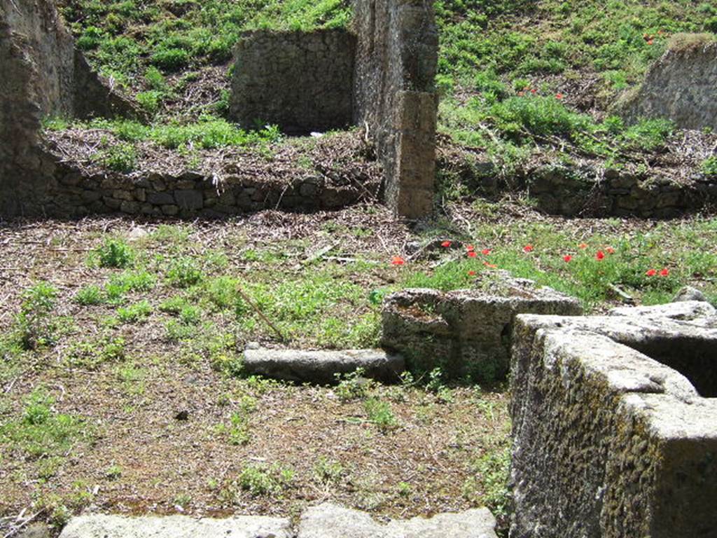 III.11.1 Pompeii. May 2006. Remains of threshold into front room, with III.11.a (side entrance). On the right of the picture is the fountain on Via Nola, and to the rear of it, the small vicolo leading south.